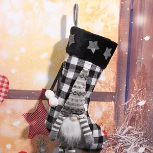 Detailed close-up of a black and white plaid Christmas stocking with cute gnome decor