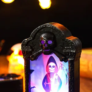 Detailed macro view of a glowing Halloween tombstone night light with skull motifs