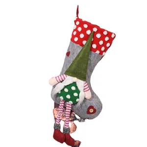 Decorative Christmas stocking featuring a long-legged gnome and red polka dot cuff gift bag