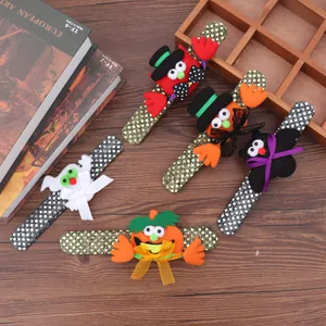 Detail of colorful Halloween sequin slap bracelets with pumpkin and ghost motifs.