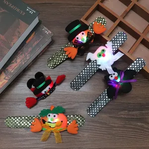 Close-up of glowing Halloween sequin slap bracelets with pumpkin ghost and bat designs