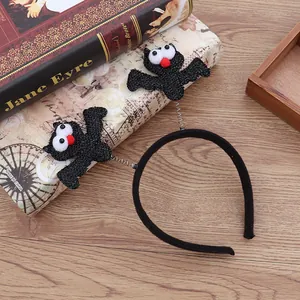 Diadema negra para Halloween con personajes de murciélago sobre resortes y ojos grandes