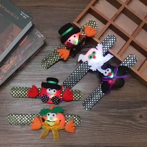 Macro detail of Halloween LED sequin slap bracelets with pumpkin and ghost motifs