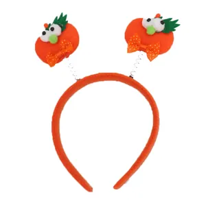 Diadema de Halloween con calabazas monstruo naranjas en resortes y lazos de lunares