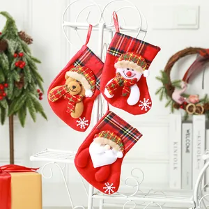 Set of three mini plaid Christmas stockings with cute 3D character decorations.
