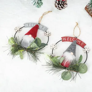 Handcrafted Christmas gnome wreaths with artificial pine needles and a festive Welcome sign.