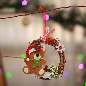 Close-up view of a Christmas wreath hanging ornament featuring a cute felt teddy bear
