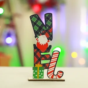 Macro view of NOEL wooden Christmas ornament featuring festive gnome and plaid patterns