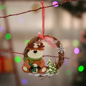 Detail of a handmade rattan Christmas wreath ornament with a cute felt reindeer.