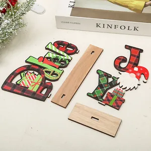 Detailed view of Christmas wooden tabletop decor featuring Believe and JOY letter plaques
