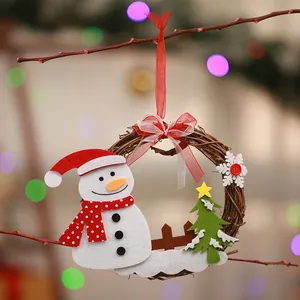 Close-up of a handmade Christmas rattan wreath with a cute felt snowman and tree.