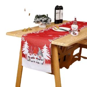 Festive red Christmas table runner with cute gnome and snowflake designs for holiday decor