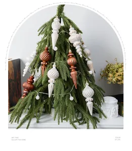 Close-up of vintage 16cm spindle Christmas ornaments in copper and white hanging on tree