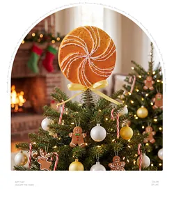 Festive gingerbread lollipop Christmas tree topper with a yellow bow and spring base