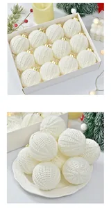Detailed view of white knitted Christmas balls set in a white box and on a plate