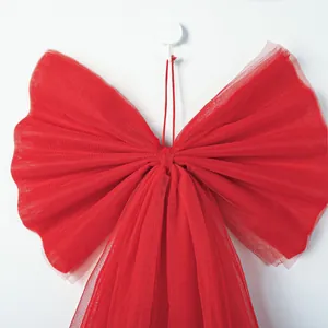 Close-up of a large red mesh bow with elegant organza texture for Christmas decor
