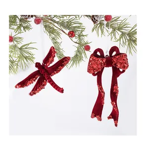 Close-up detail of red flocked dragonfly and bow Christmas ornaments with shiny sequins
