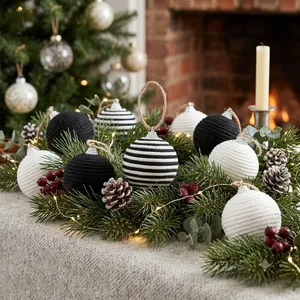 Close-up detail of black and white knitted Christmas ball ornaments with woven texture