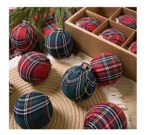 Close-up detail of festive red and green plaid Christmas ball ornaments with fabric texture