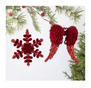 Detailed view of red sequined and flocked snowflake and wing Christmas ornaments
