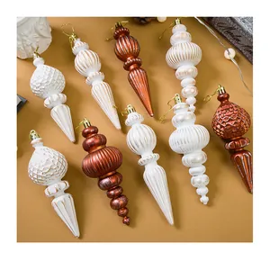 Assorted vintage spindle Christmas ornaments in elegant white and bronze metallic finishes