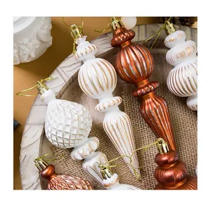 Macro view of vintage pointed Christmas ornaments in pearl white and antique copper finish