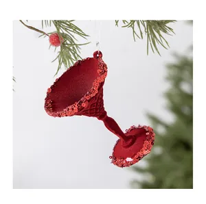Detailed view of a red flocked martini glass Christmas ornament decorated with sequins