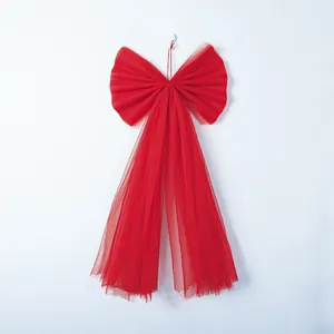 Large red organza bow with long streamers for festive window or Christmas tree decoration.