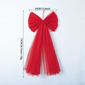 Detailed view of large red organza bow with size markings for Christmas tree topper.