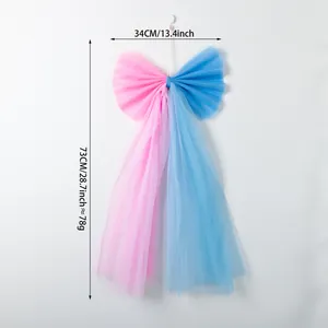 Close-up of a large pink and blue tulle bow with dimension markings 34cm x 73cm