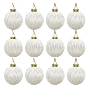 Set of 12 elegant white knitted Christmas ornaments with gold caps for tree decoration.