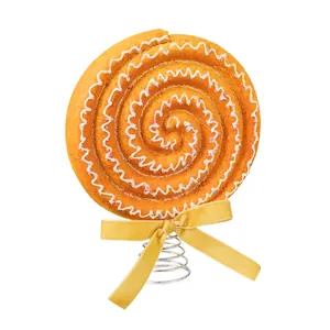 Festive swirl lollipop Christmas tree topper with yellow velvet bow and spring base.