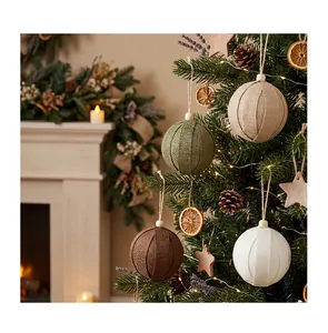 Detailed view of rustic burlap Christmas ball ornaments hanging on a festive tree.