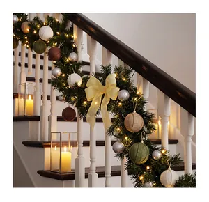 Close-up of rustic burlap Christmas ball ornaments on a festive pine garland