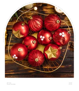 Red Christmas balls with gold star patterns in a gold wire basket for holiday decor.