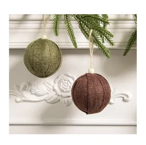 Detail view of green and brown burlap Christmas ball ornaments with twine hangers