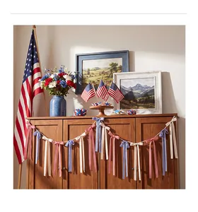 Close-up detail of patriotic fabric bow garland for Independence Day party decoration.