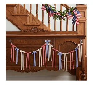 Patriotic bow garland with red, white, and blue ribbons hanging on a wooden cabinet
