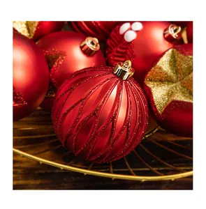 Detailed view of festive red Christmas ornaments with glitter patterns in a wire basket