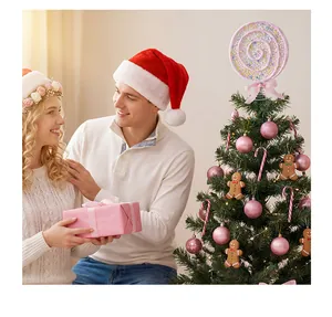 Glittery pink lollipop Christmas tree topper shown in a festive holiday scene with a couple.