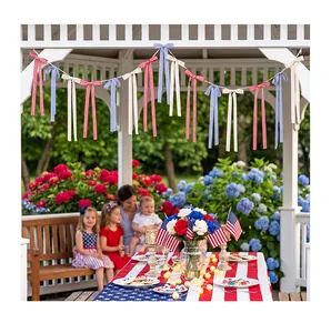 Patriotic fabric bow garland hanging in a garden gazebo for Independence Day party decor.