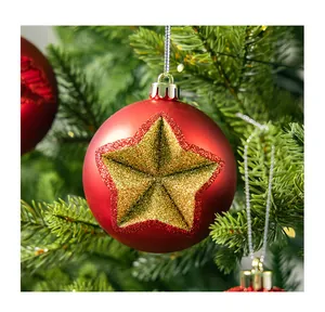 Detailed macro view of red Christmas ball ornament featuring a shimmering gold star design.