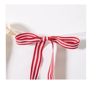 Detail of red and white striped fabric bow for Independence Day party banner