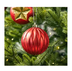 Close-up of red glitter wave pattern on Christmas ball ornament hanging on tree