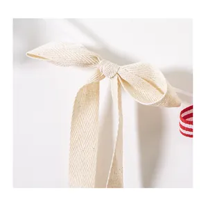 Macro detail of a cream herringbone fabric bow for Independence Day party banner decor