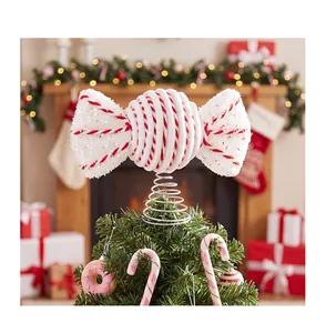 Detailed macro view of a red and white striped foam candy tree topper on a tree