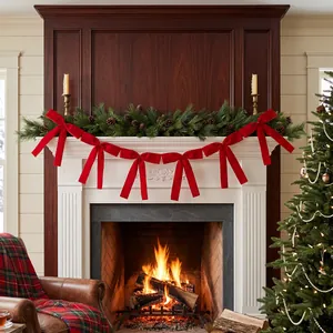 Festive red ribbon bow garland decorating a classic fireplace mantel during Christmas