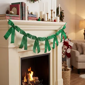 Green glitter bow garland decoration draped on a festive Christmas fireplace mantel