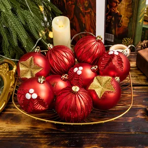 A set of festive red Christmas ornaments with gold glitter stars in a wire basket
