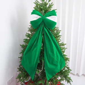 Grande fiocco decorativo verde e bianco con paillettes appeso a un albero di Natale.